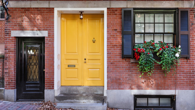 yellow door on brick house