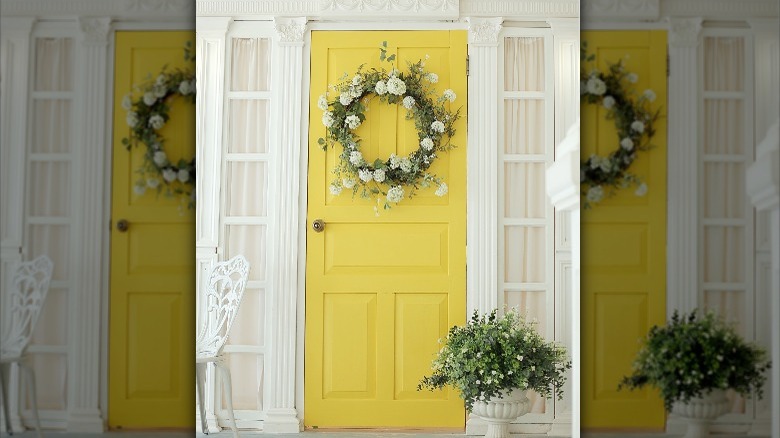 yellow door with flower wreath