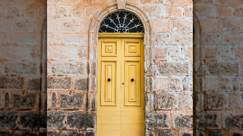 yellow door on brick house