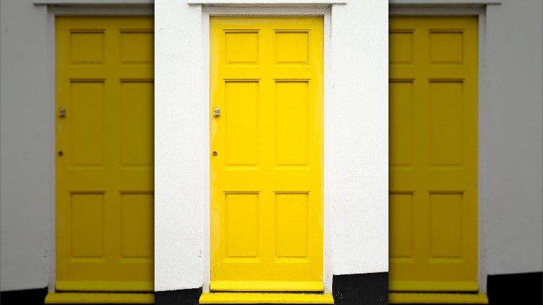 yellow door on white house