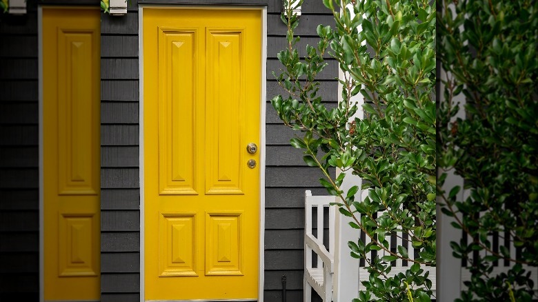 yellow door on gray house