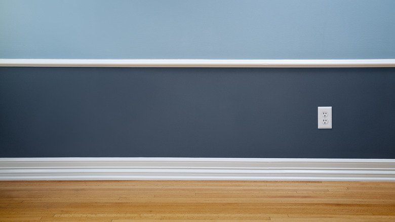 white baseboard on blue wall