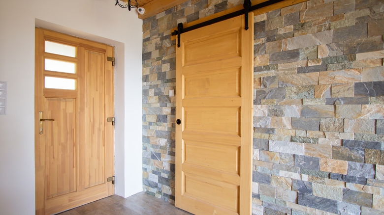 Hallway closet with a sliding barn door