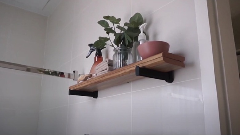 DIY floating shelf on tiled bathroom wall