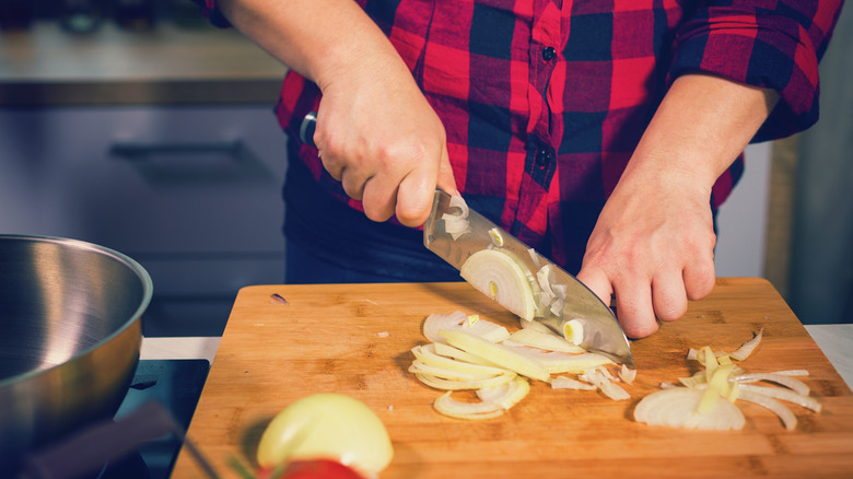 slicing onions on cutting board