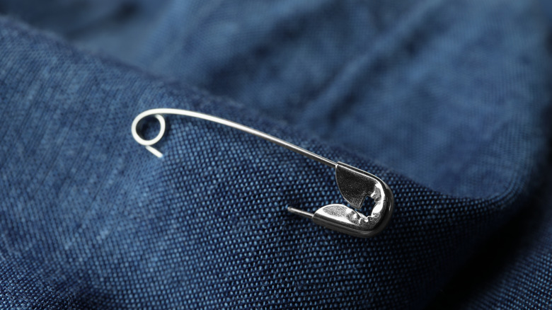 safety metal pin on blue cloth