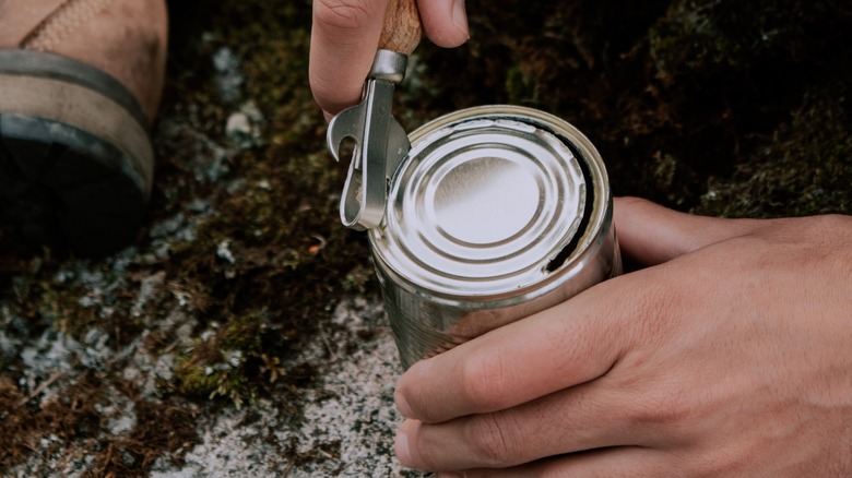 Person removing can lid