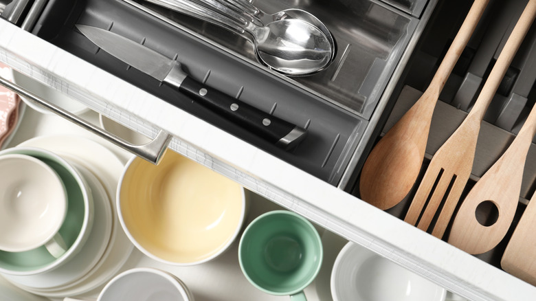 Kitchen drawers with tray of utensils and cups