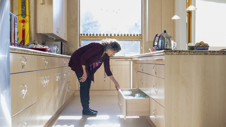 Someone opening a large kitchen drawer