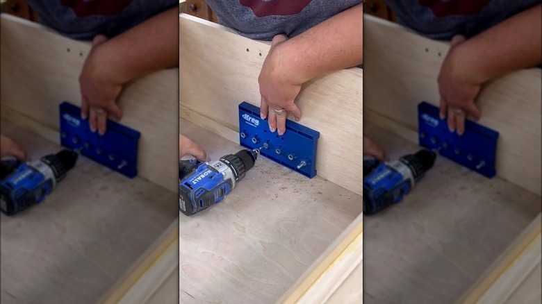 person drilling holes for drawer pulls