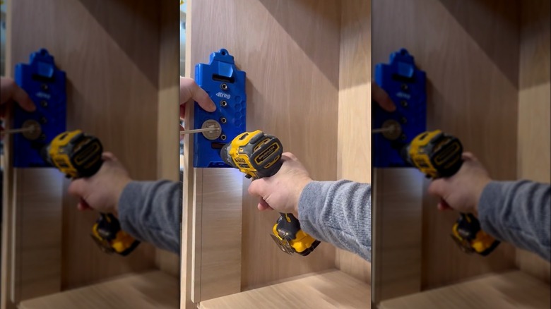 person drilling holes for a shelf