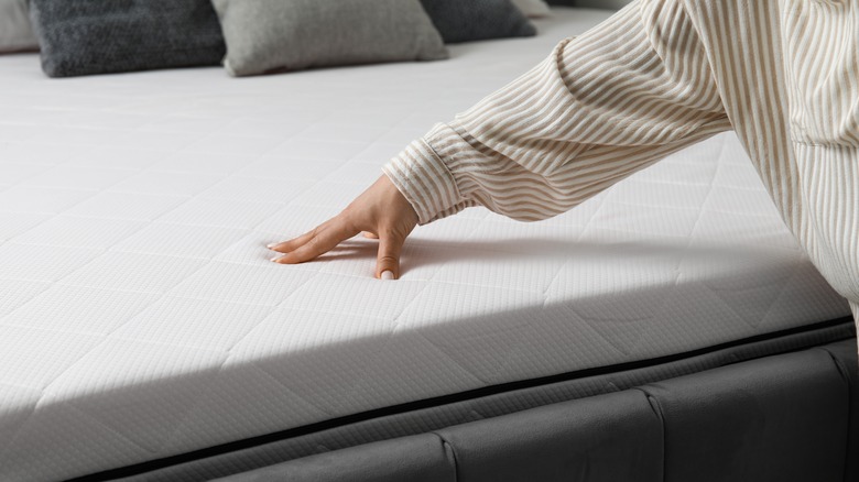 Woman touches clean mattress