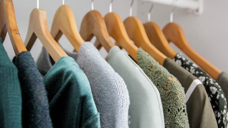 sweaters hanging in closet