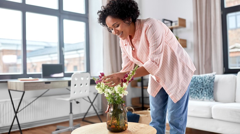 Person decorating coffee table