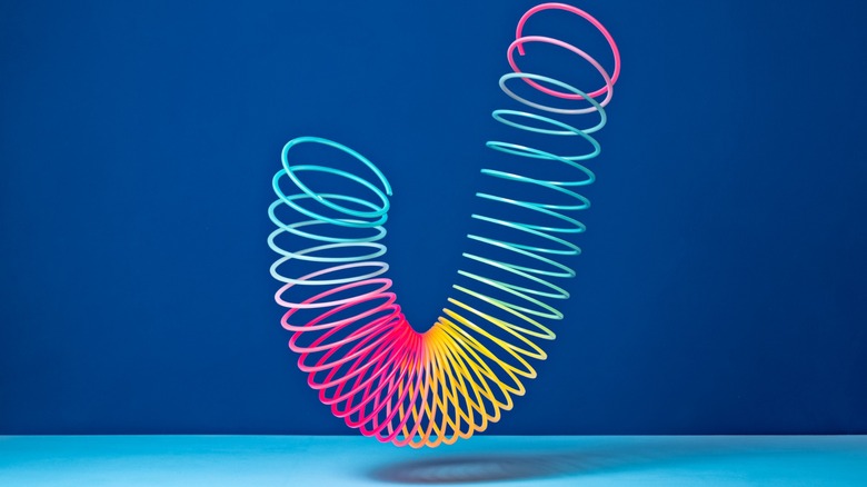 Rainbow colored slinky falling from the sky