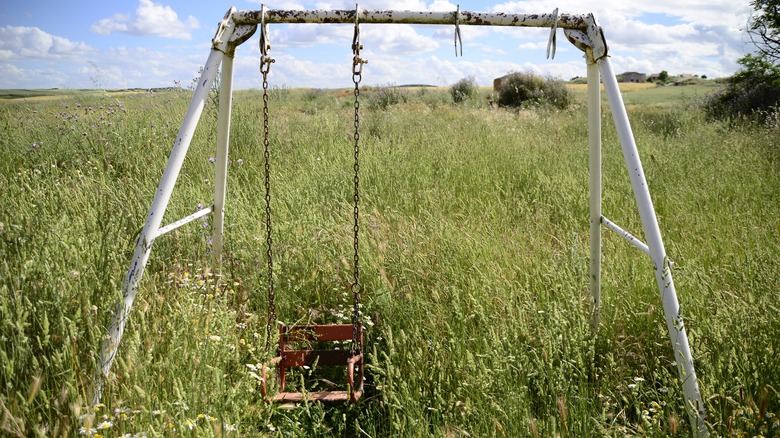 old swing set in field