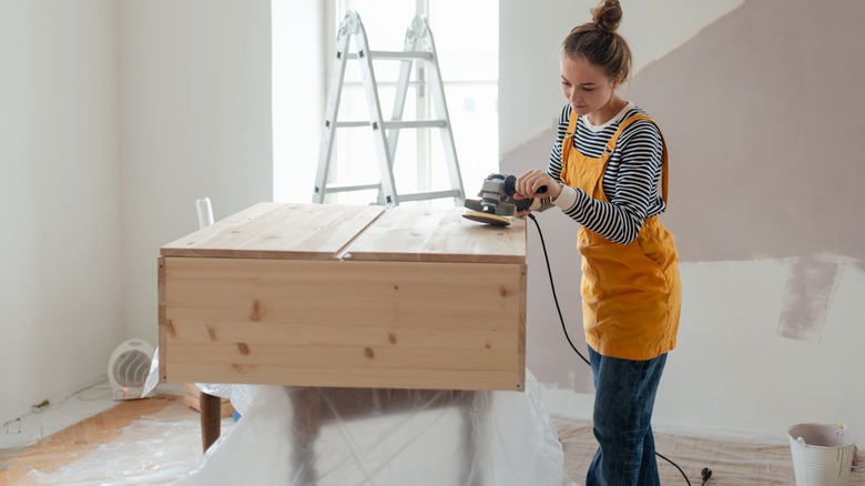 Woman sands cabinet