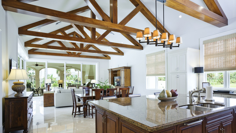 Large open concept room with wood beams