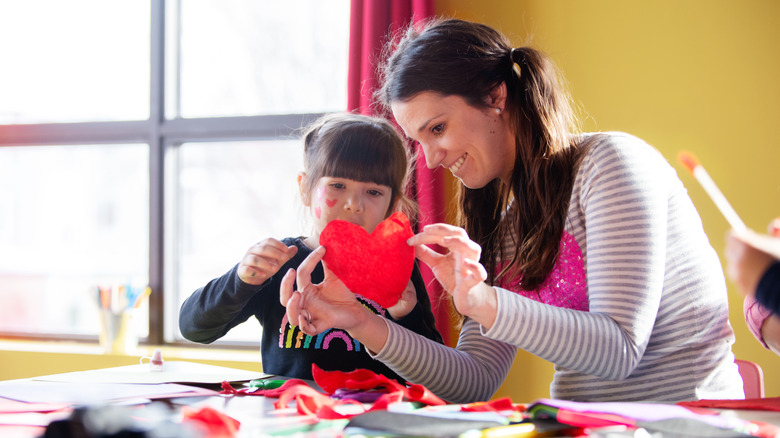 Woman and child paper hearts