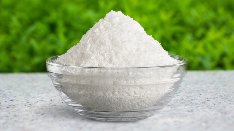 A bowl of Epsom salt is placed on the ground outside