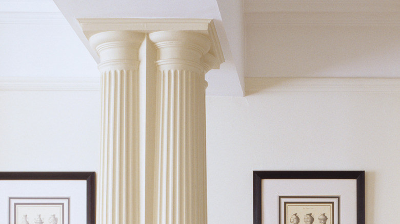 An older room with a neutral color palette and ornate ridged pillars