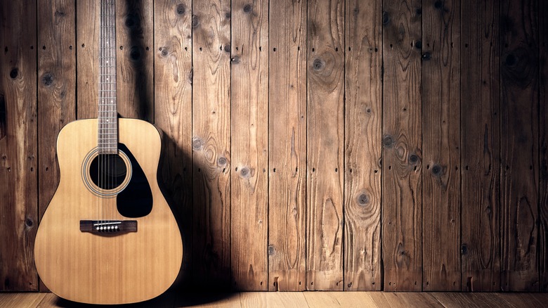 guitar leaning on wall