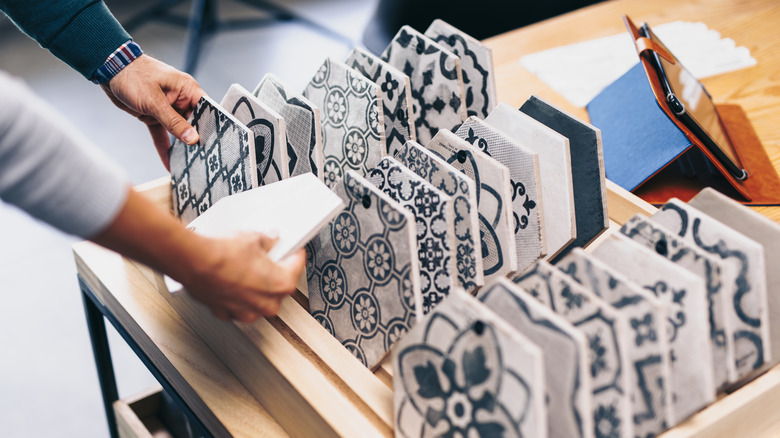 customers holding mosaic tiles 