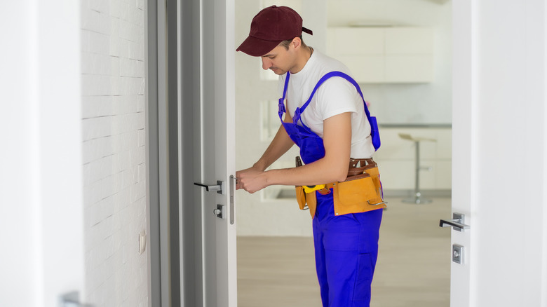 Man drilling front door