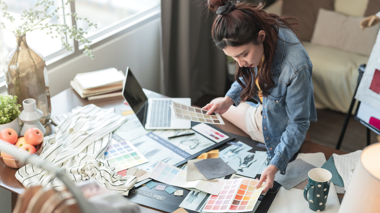 This person is looking at colors and fabrics.