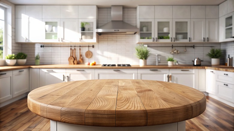 Round wooden countertop sits in the middle of a kitchen