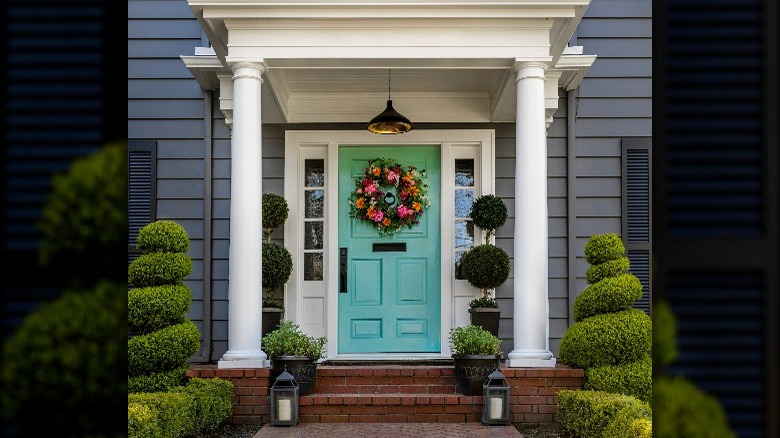 Turquoise door dark gray siding