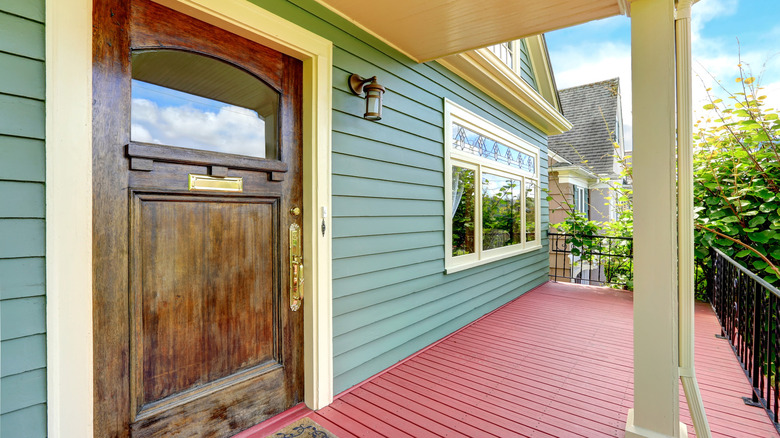 Dark teal siding red porch