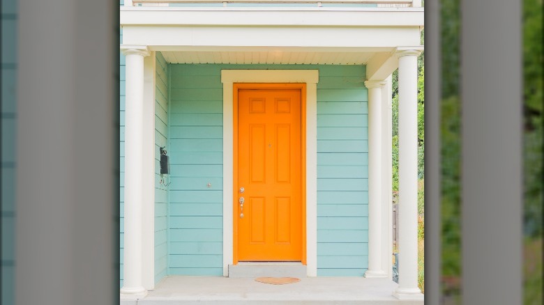 Light blue siding orange door