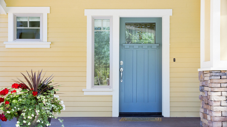 Yellow siding blue front door