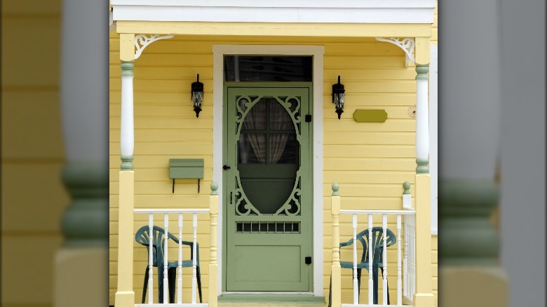 Yellow siding and green door