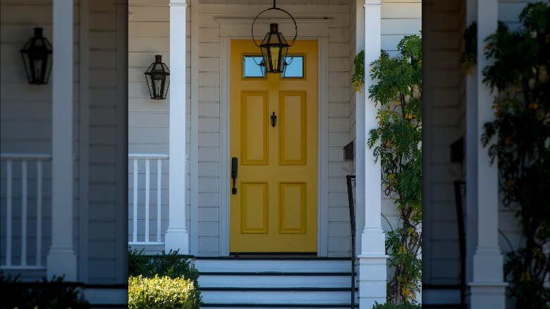 Yellow front door white siding