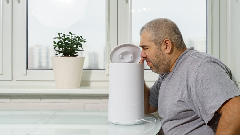 Man detecting bad humidifier smell