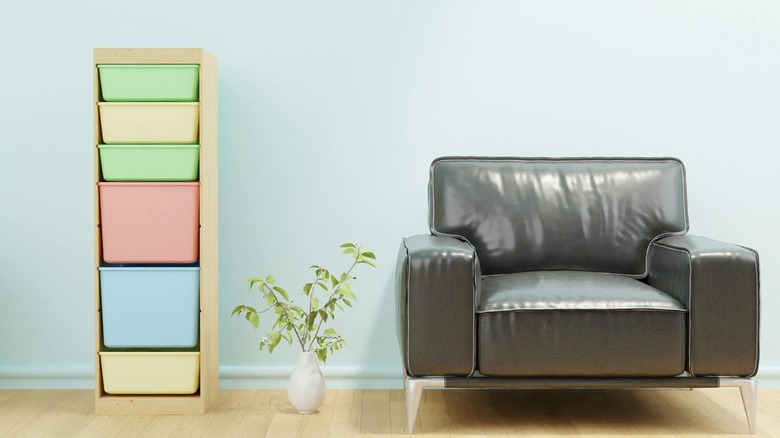 single TROFAST unit with multi-colored shelves next to modern leather chair