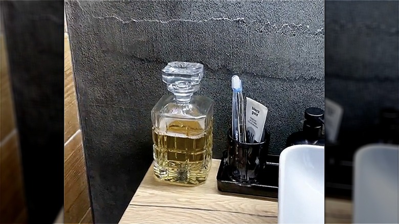 decanter with mouthwash in bathroom