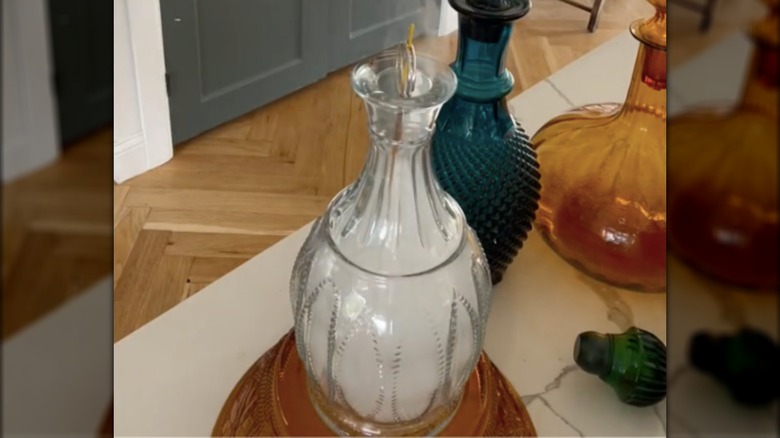 burning incense in decanter bottle