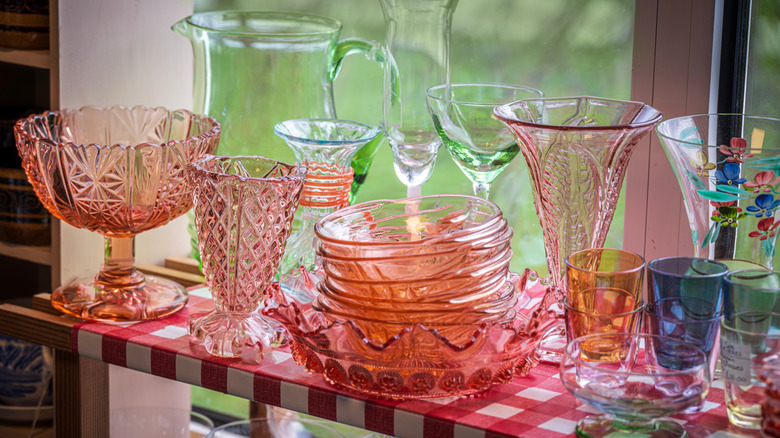 Various styles of vintage glassware on a shelf