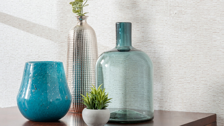 Various styles of glassware used as decor or planters.