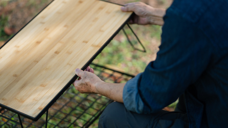 Wooden table topper being held by a man