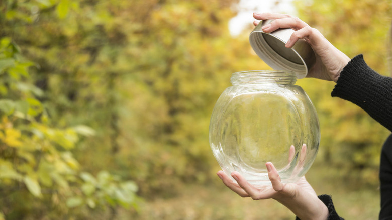 opening glass jar in garden