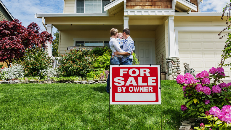 Family standing outside home for sale