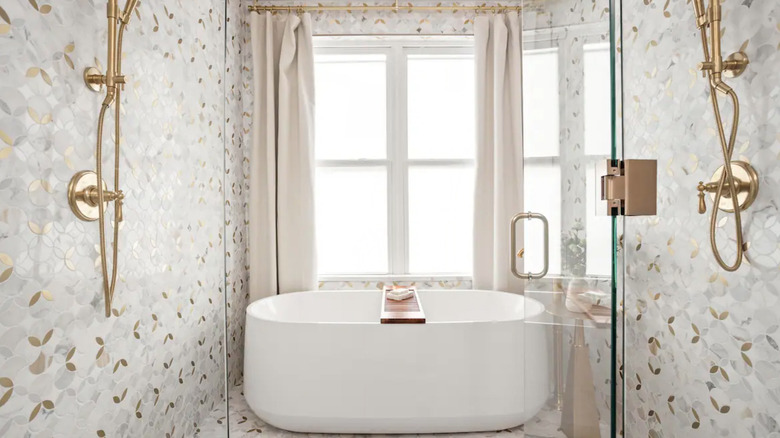 white bathtub with pink curtains