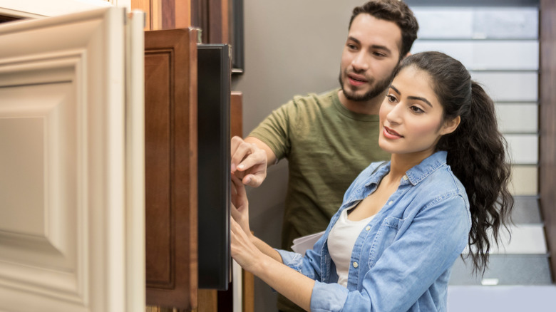 Couple shopping for wood cabinets