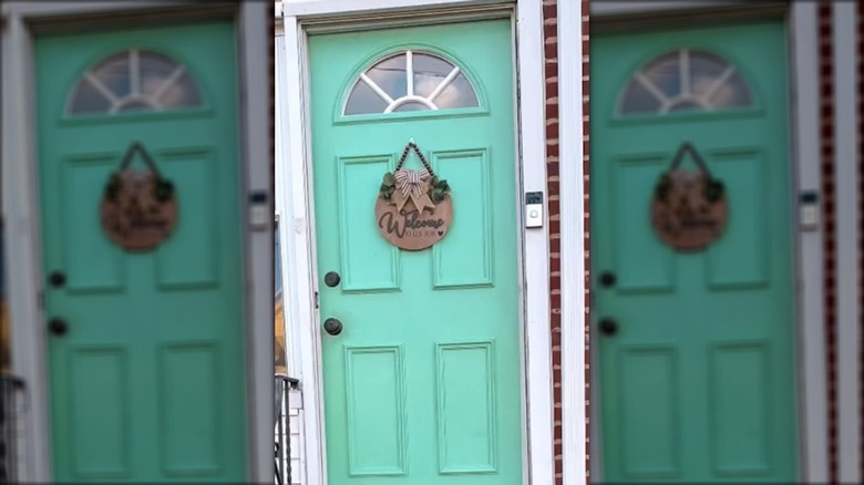 Welcome sign on a turquoise door