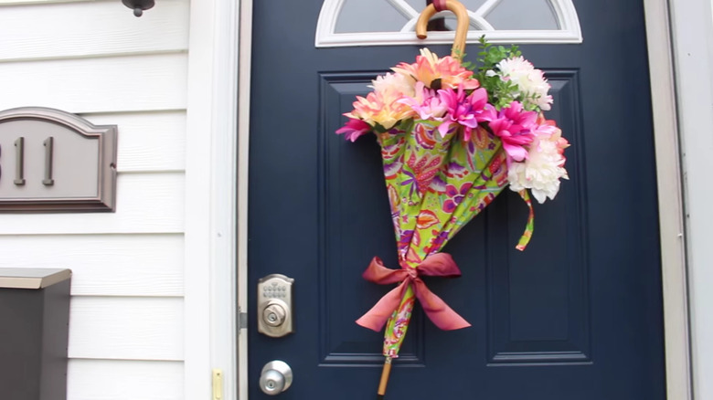 Flowers in an umbrella hanging on a front door