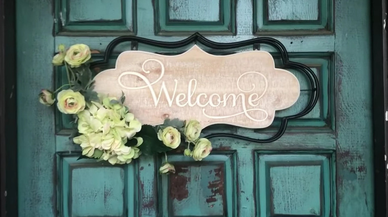 Welcome sign on a blue door